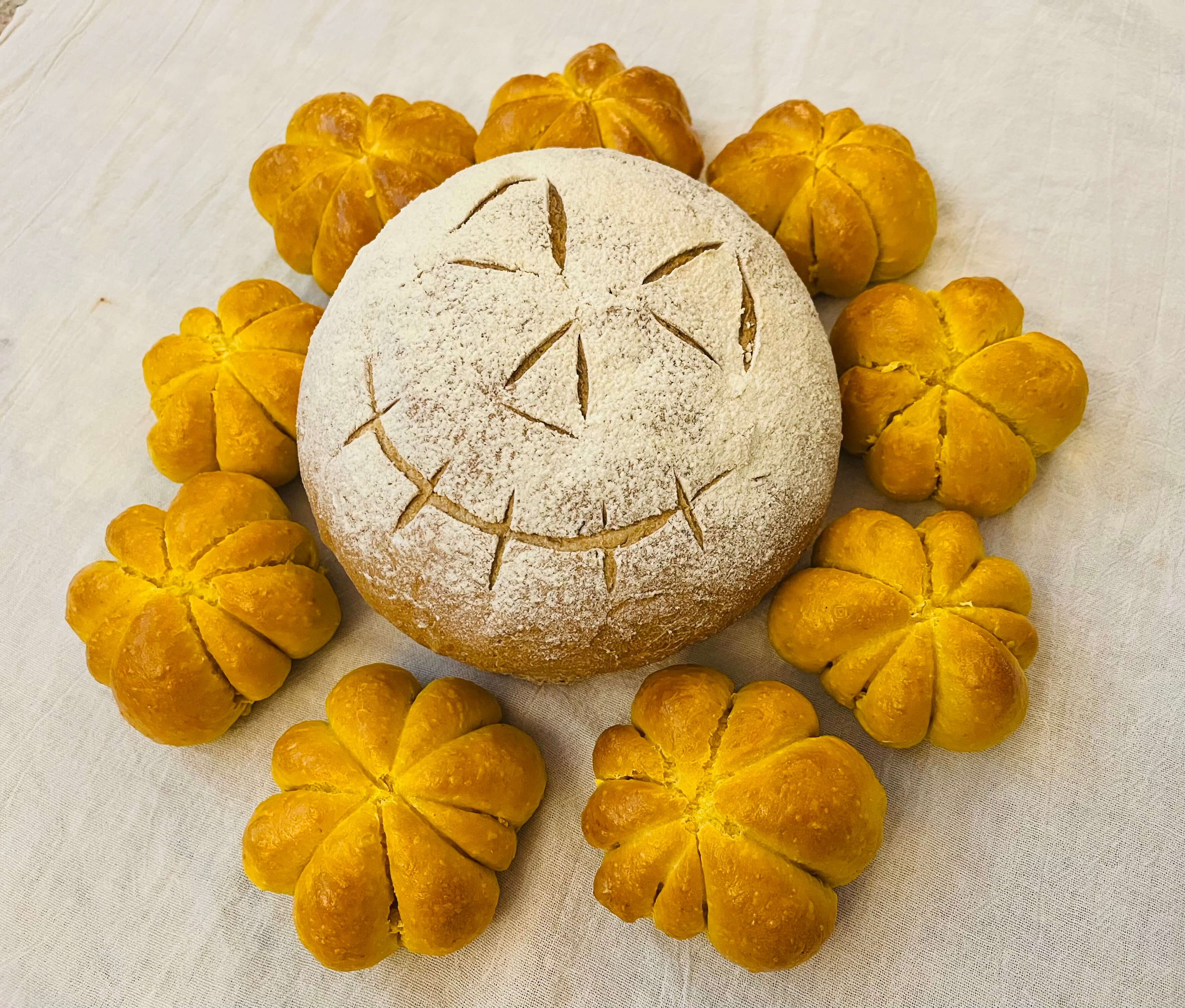 Spooky whole wheat rosemary sandwich bread carved with a skeleton face.