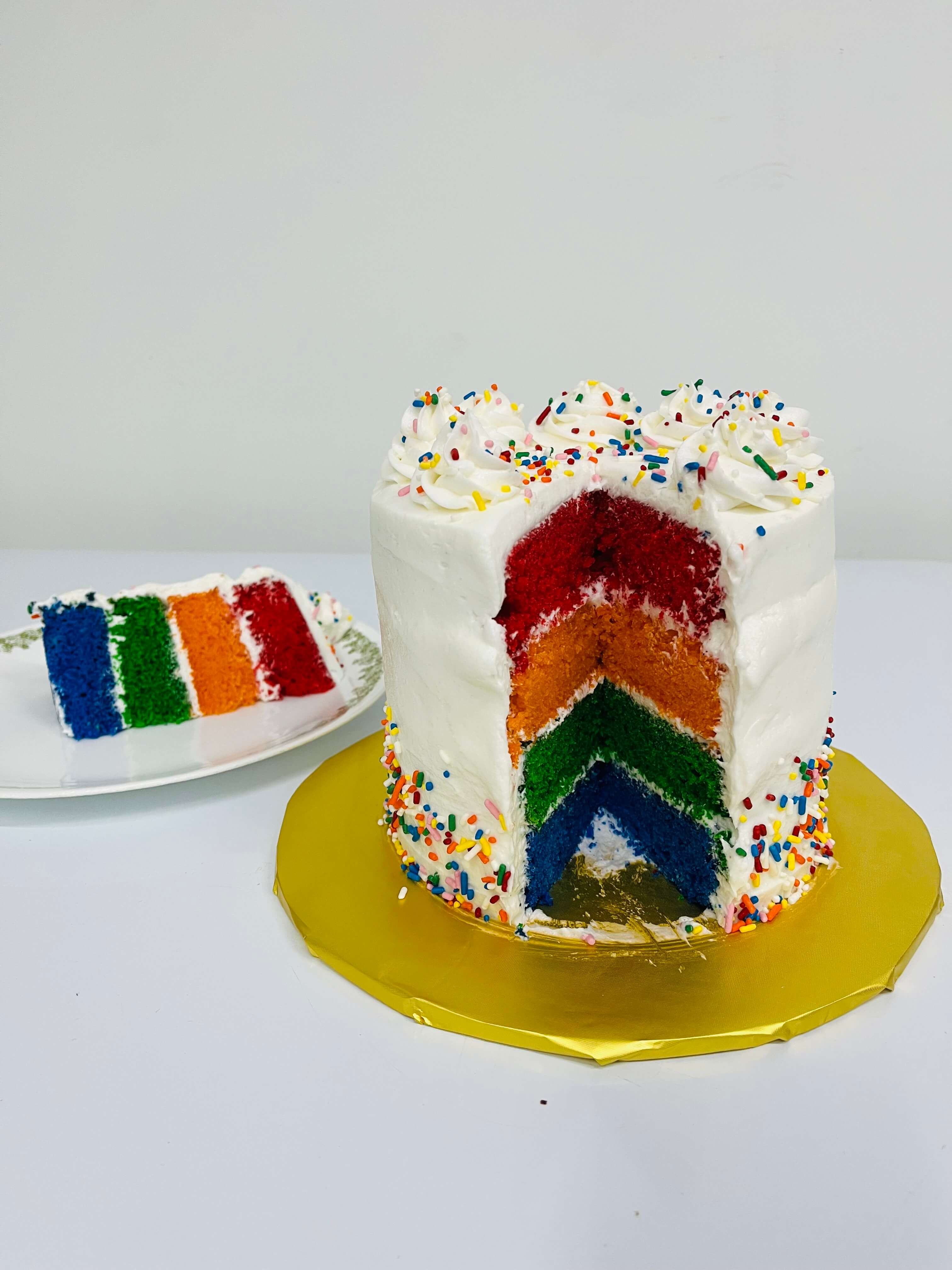 Decorated simple sprinkle cakes with rainbow colored cake.