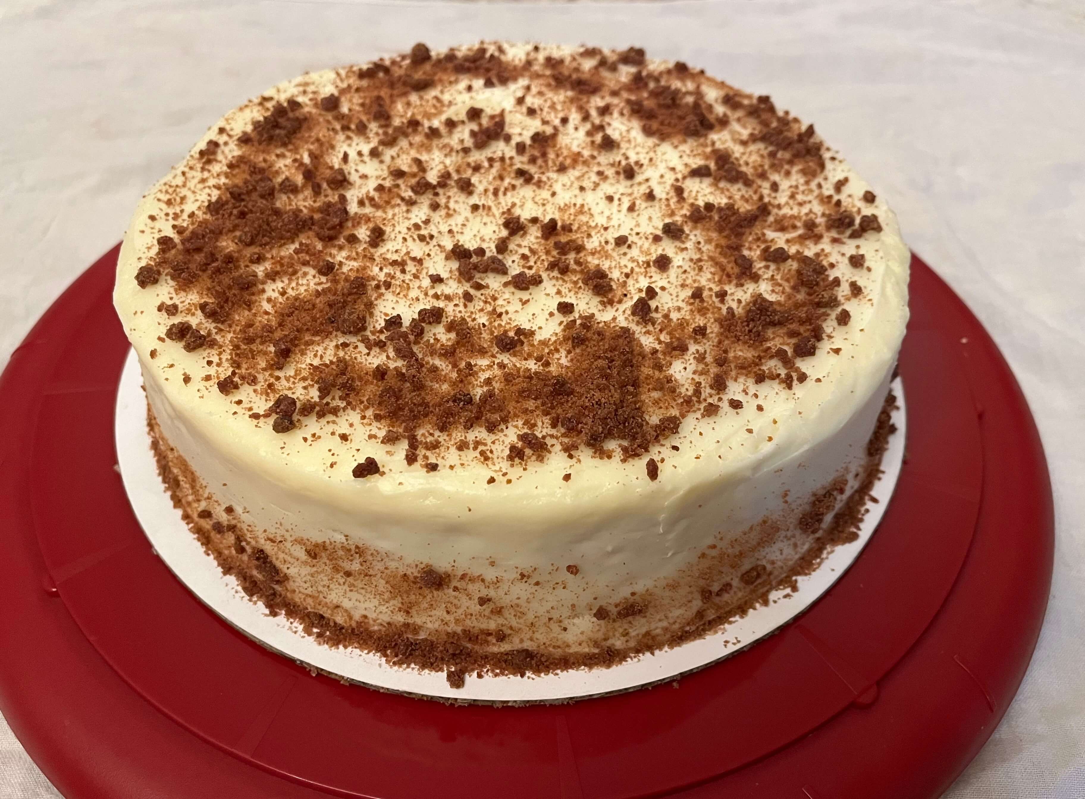 Slice of natural red velvet cake with cream cheese frosting