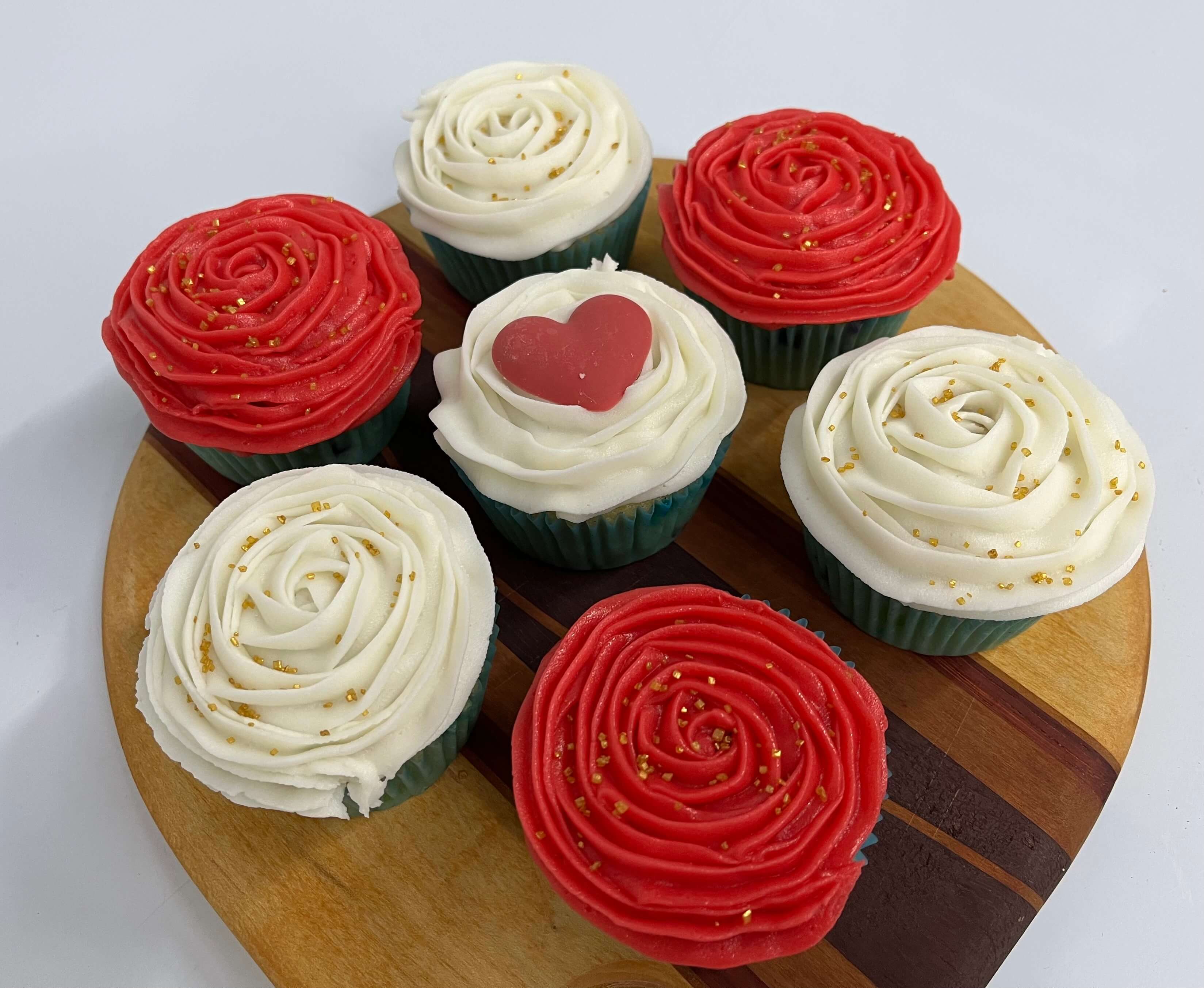 Vanilla funfetti cupcakes with red and white flowers frosting.